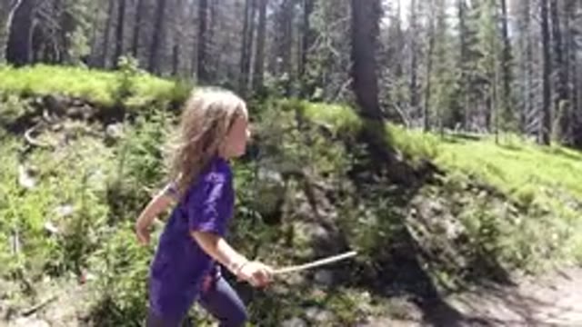 WINTER PARK COLORADO-2019: Little Girl Recorded Running In The Woods With A Stick