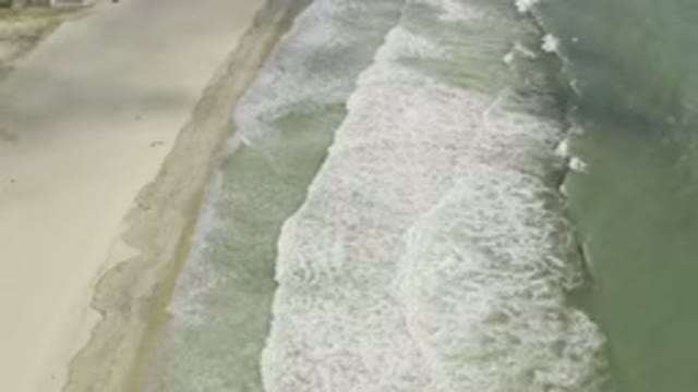 LOS CABOS MEXICO-2019: Waves Crash Along A Shoreline Of Green And Blue Waters
