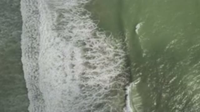 LOS CABOS MEXICO-2019: Oddly Looking Green Water Sea With Slow Waves Crashing At