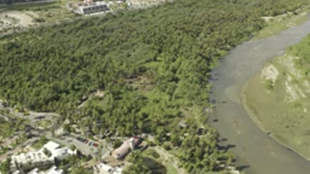 LOS CABOS MEXICO-2019: Car Drives Away From Parking Lot On A Winding Road