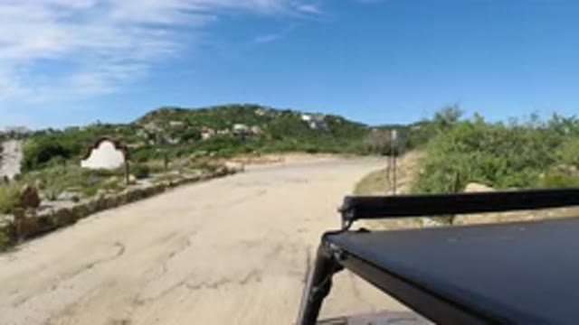 LOS CABOS MEXICO-2019: Car Sitting On A Big Open Dirt Road Admiring Scenery