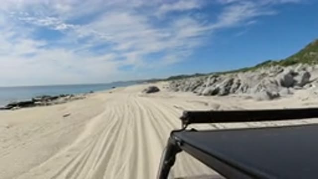 LOS CABOS MEXICO-2019: Car Footage Driving Through A Sunny Sandy Expanse Near A