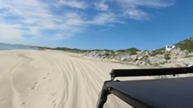 LOS CABOS MEXICO-2019: A Vehicle Driving On The Shore Of A Beach On A Cloudy Day
