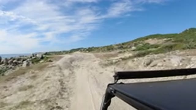 LOS CABOS MEXICO-2019: Camera in Car Walking on Dirt Road with Bushes Around