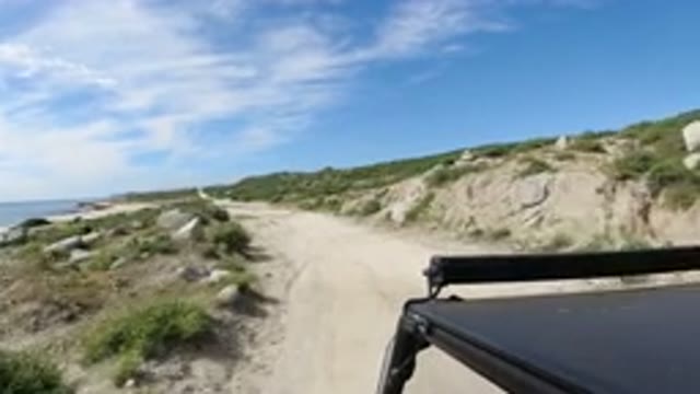 LOS CABOS MEXICO-2019: A Vehicle Moving Near A Beach Sandy Road And Beautiful