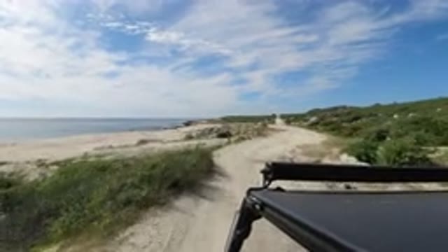 LOS CABOS MEXICO-2019: A Vehicle Moving On A Sand Stone Road Near By A Beach