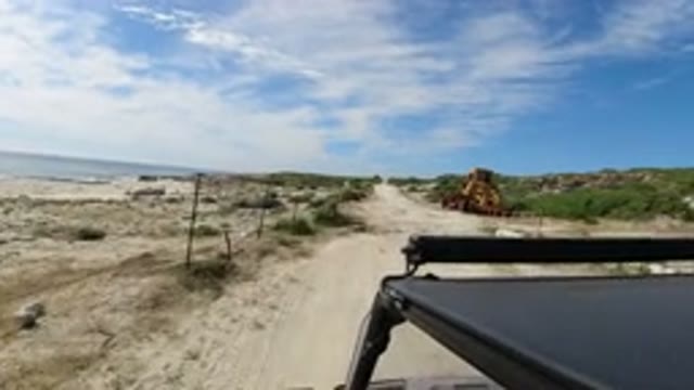 LOS CABOS MEXICO-2019: Jeep Slowly Driving Through Beach Road During The Afternoon