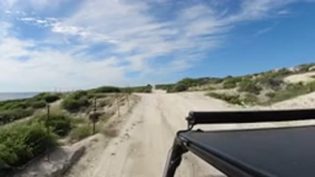 LOS CABOS MEXICO-2019: A Small Black SUV Is Riding At Moderate Speed On A Sand