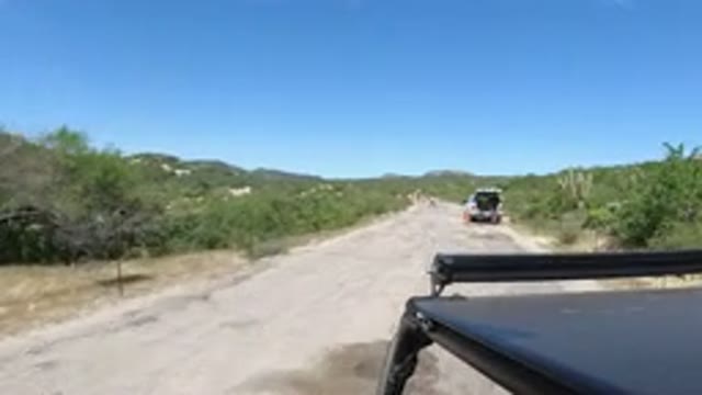 LOS CABOS MEXICO-2019: Driving On A Dirt Road Passing A Vehicle With A Flat Tire