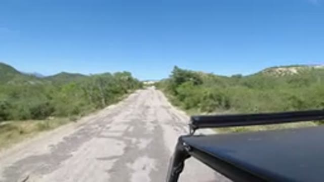 LOS CABOS MEXICO-2019: Car Driving Open Road Passing Motorbike in Countryside