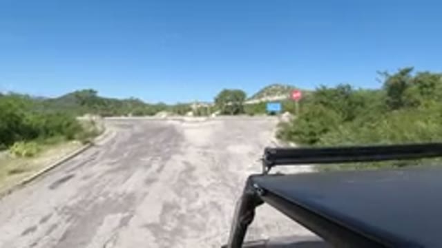 LOS CABOS MEXICO-2019: A Small Black SUV Is Riding At A Fast Speed Down An Empty Road