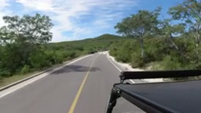 LOS CABOS MEXICO-2019: A Vehicle Travels on a Narrow Road on a Sunny Day