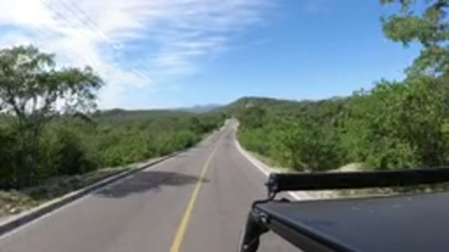 LOS CABOS MEXICO-2019: Black Vehicle Takes A Cruise Down Open Road Enjoying The