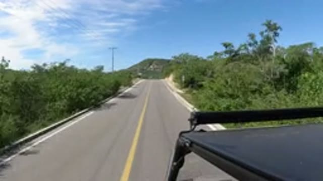 LOS CABOS MEXICO-2019: Jeep Driving Through The Highway With Plenty Of Vegetation And Mountains