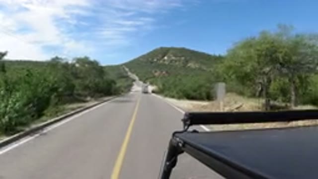 LOS CABOS MEXICO-2019: A Vehicle Driving On A Narrow Road On A Sunny Day