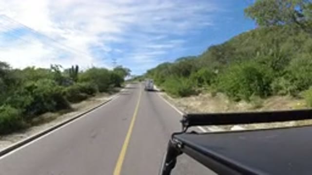 LOS CABOS MEXICO-2019: A Black SUV Is Driving Mighty Fast Down The Road Behind