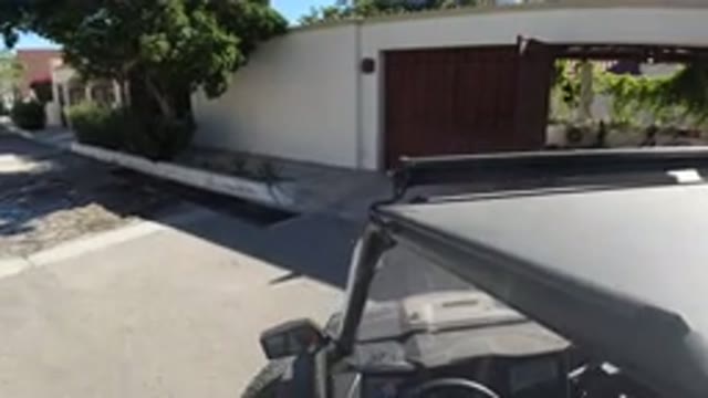LOS CABOS MEXICO-2019: Vehicle Backing Out Of A Gated Driveway And Closing The Gate