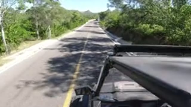 LOS CABOS MEXICO-2019: Car Driving Through The Highway With Lots Of Trees To