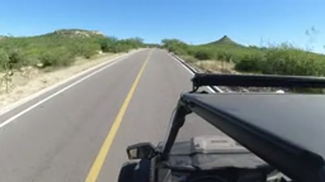 LOS CABOS MEXICO-2019: Driving On A One Lane Road In An Area Of Brush And Small
