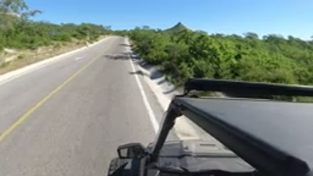 LOS CABOS MEXICO-2019: A Car Pulling Over On The Side Of A Two-Lane Road