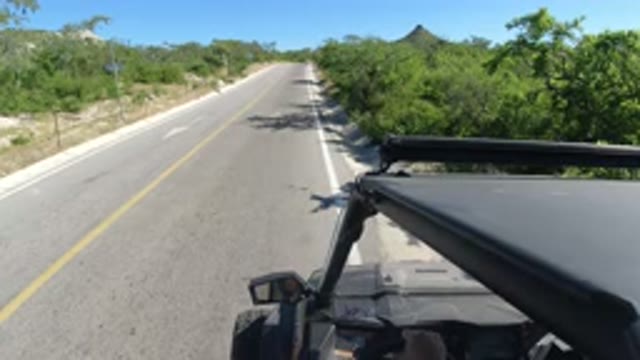 LOS CABOS MEXICO-2019: A Small Black SUV Is Sitting On The Side Of The Road