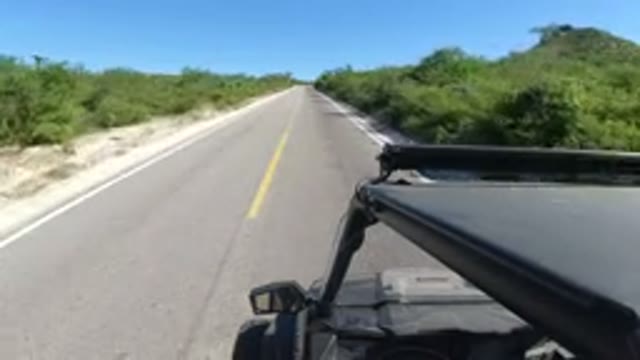 LOS CABOS MEXICO-2019: A Fast Moving Vehicle Through A Straight Two Way Road