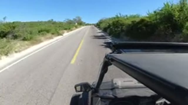 LOS CABOS MEXICO-2019: A Mini Black Truck Is Driving At A Moderate Speed Down The