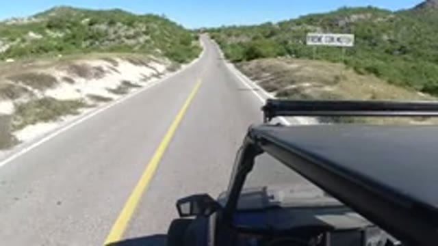 LOS CABOS MEXICO-2019: Car Going Through The Highway With Plenty Of Vegetation
