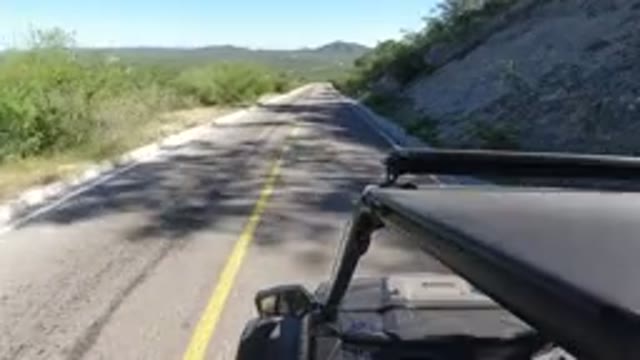LOS CABOS MEXICO-2019: A Vehicle Driving On A Narrow Road On A Sunny Day
