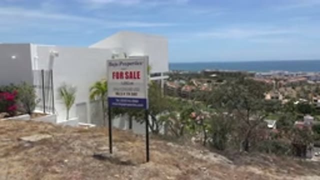 LOS CABOS MEXICO-2020: Hill Top View Of A White Building And For Sale Board And