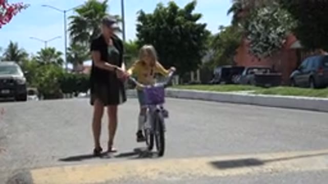 LOS CABOS MEXICO-2020: Young Girl On A Bike With Her Mother