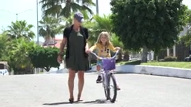 LOS CABOS MEXICO-2020: Woman Teaching A Young Girl To Ride A Bicycle On A Quiet