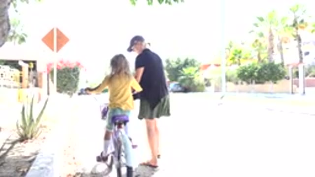 LOS CABOS MEXICO-2020: Child Rides Bicycle With Mother On Empty Road