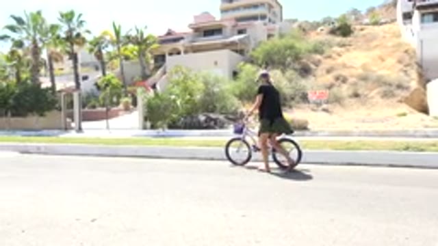 LOS CABOS MEXICO-2020: Mother Guides Her Daughter While Riding a Bicycle
