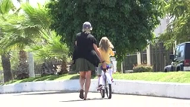 LOS CABOS MEXICO-2020: Mother Teaching Her Child To Ride A Bicycle Along The