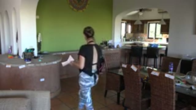 LOS CABOS MEXICO-2020: Woman And Child Walking Around In House Showing Kitchen