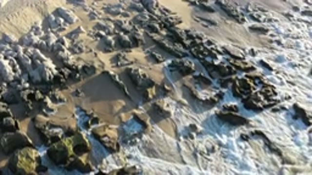 LOS CABOS MEXICO-2020: Waves Of A Sea Crashing On Rocks And Small Rocks On A Beach