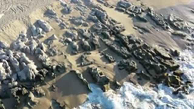 LOS CABOS MEXICO-2020: Rocks In Ocean Roaming Freely In The Sand While Ocean