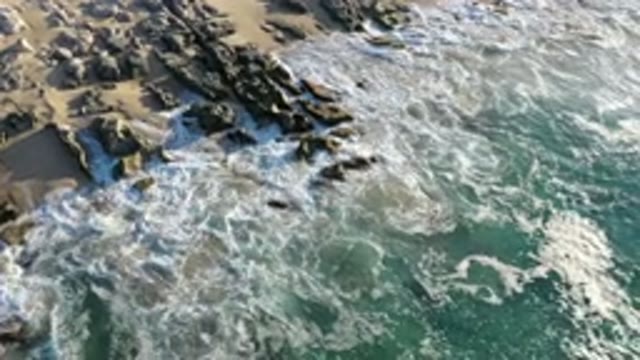 LOS CABOS MEXICO-2020: Aerial Footage Of Blue Waves Crashing Onto Rock-Laden Shoreline