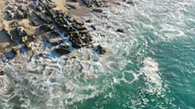LOS CABOS MEXICO-2020: Green Ocean Water Crashes Into Foamy White