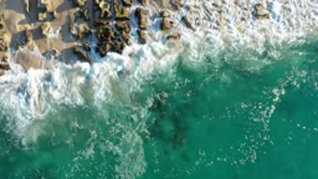 LOS CABOS MEXICO-2020: Wave Going On The Sand And Rocks On A Sandy Beach With