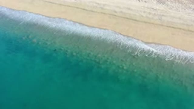 LOS CABOS MEXICO-2020: Ebb And Flow Of The Tide Of An Emerald Green Ocean Along