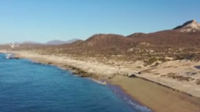 LOS CABOS MEXICO-2020: Aerial Shot Of The Ocean Shore Against An Arid And Mountainous Landscape