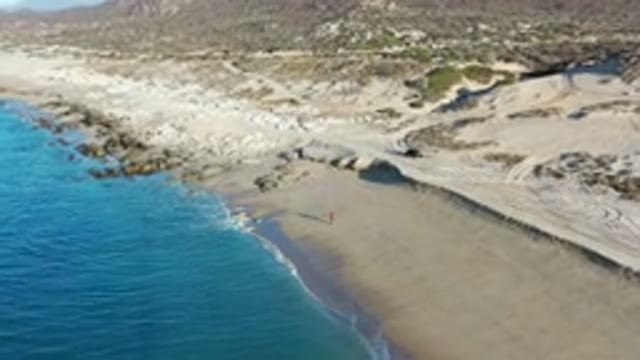 LOS CABOS MEXICO-2020: Aerial View Of Sandy Beach With Waves Lapping At The