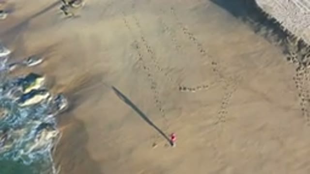 LOS CABOS MEXICO-2020: Aerial View Of Man Standing On Beach As We Move Past To