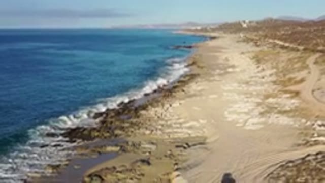 LOS CABOS MEXICO-2020: Panning Down A Pristine Natural Beach With Soft Blue Waves