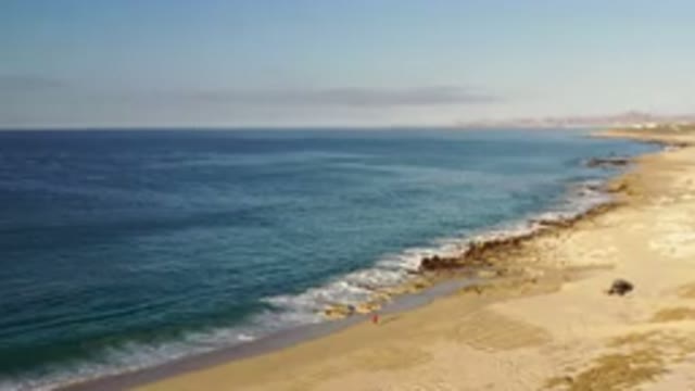 LOS CABOS MEXICO-2020: Clear Sky Above Deep Blue Ocean With Waves Washing Ashore