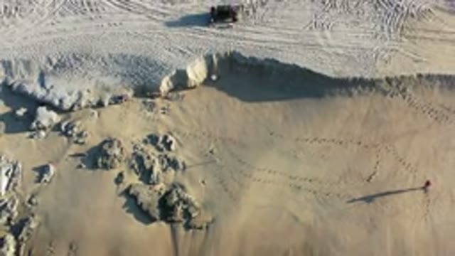 LOS CABOS MEXICO-2020: Off Road ATV Tracks In The Sand With A Person Walking