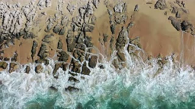 LOS CABOS MEXICO-2020: Ocean Waves Crashing Against Rocks On Beach