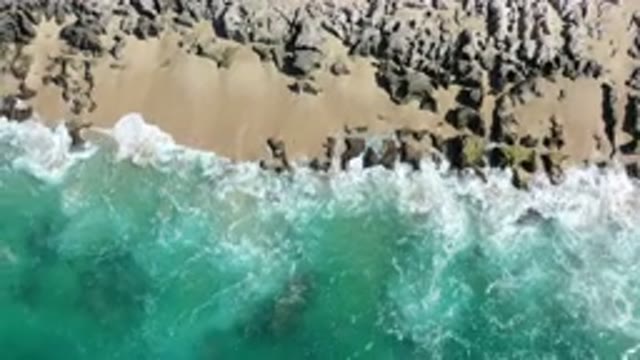 LOS CABOS MEXICO-2020: Blue Colored Sea Water Crashing Upon Rocky Cliffs
